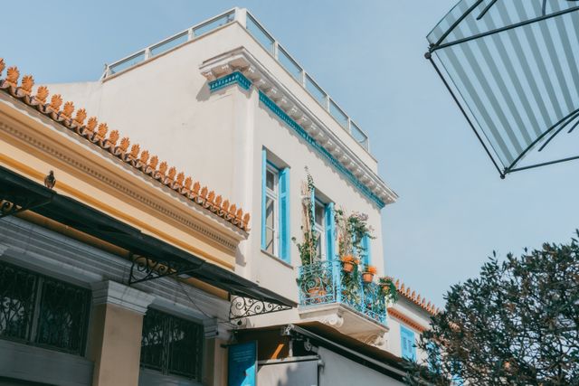 Neoclassical Athens building with blue balcony and terracotta roof